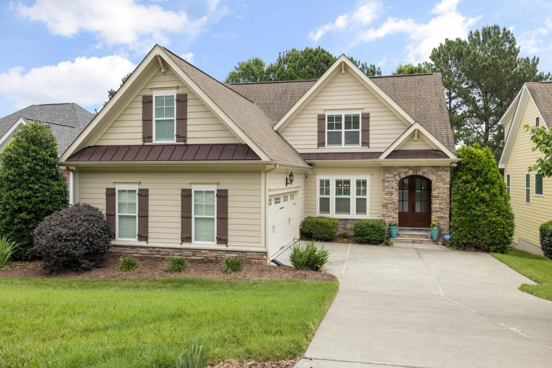 Manicured front lawn and planting beds in front of a home.