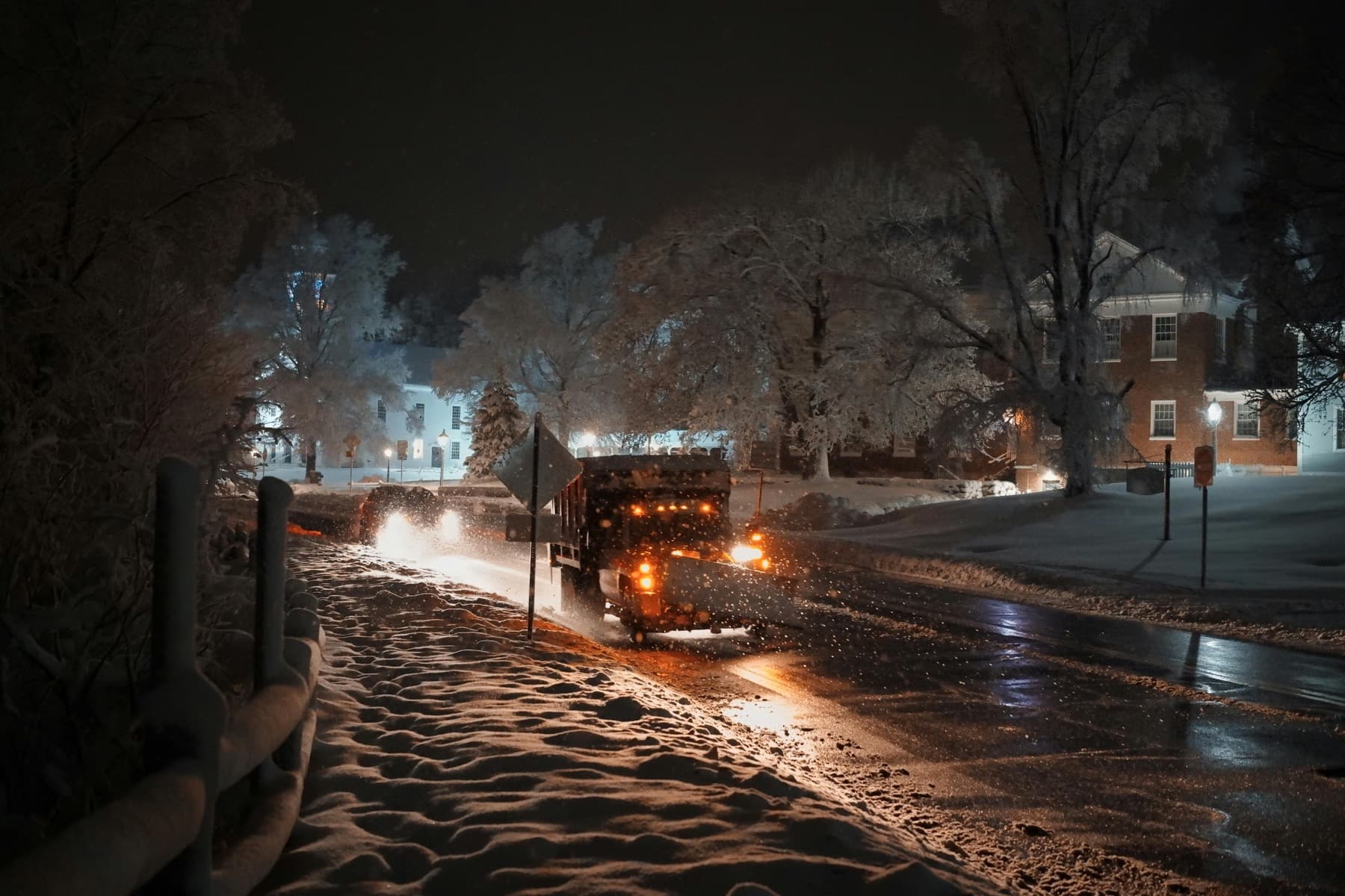 Snow plow clearing a snowy street during winter service.